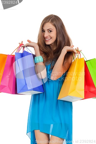 Image of attractive young woman with colorful shopping bags isolated