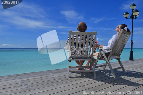 Image of happy young couple relax and take fresh drink