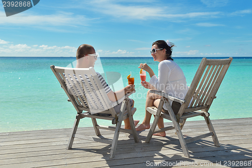 Image of happy young couple relax and take fresh drink