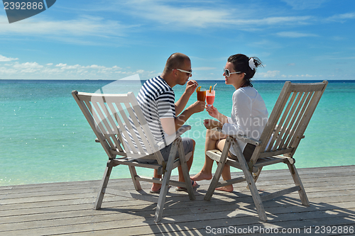 Image of happy young couple relax and take fresh drink