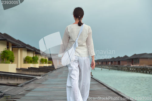 Image of young woman relax on cloudy summer day