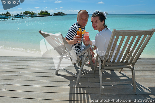 Image of happy young couple relax and take fresh drink