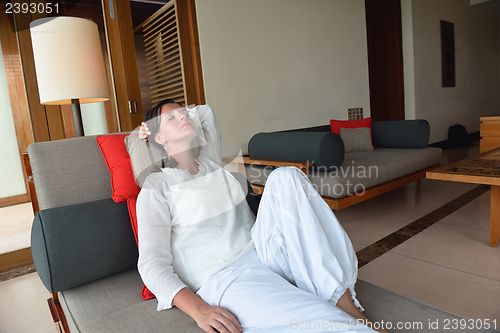Image of happy young woman relax at home on sofa