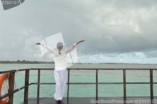 Image of young woman relax on cloudy summer day