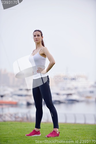 Image of Young beautiful  woman jogging  on morning