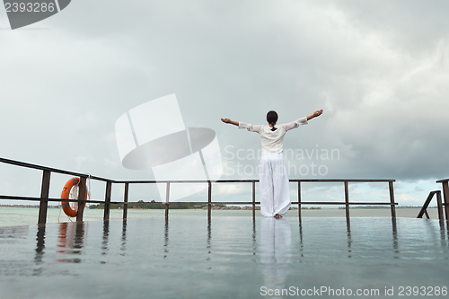 Image of young woman relax on cloudy summer day