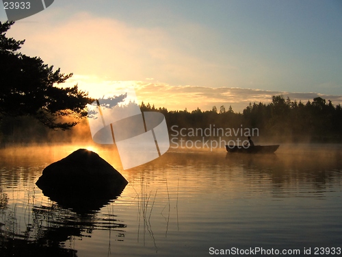 Image of Rowing boat in a lake at sunrise.