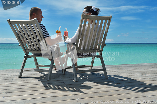 Image of happy young couple relax and take fresh drink