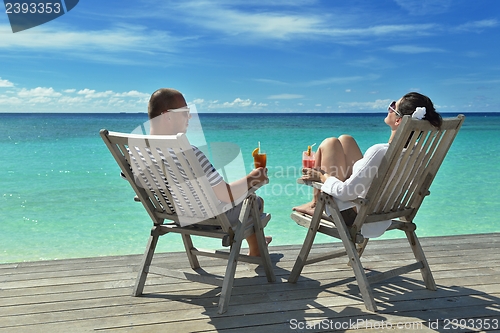 Image of happy young couple relax and take fresh drink