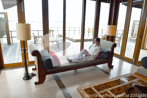 Image of happy young woman relax at home on sofa