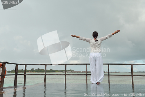Image of young woman relax on cloudy summer day