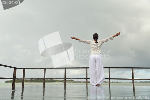 Image of young woman relax on cloudy summer day