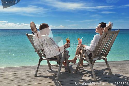 Image of happy young couple relax and take fresh drink