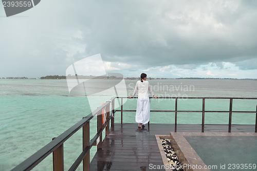 Image of young woman relax on cloudy summer day