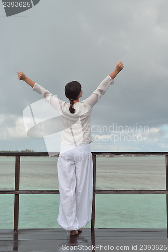 Image of young woman relax on cloudy summer day