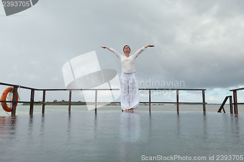 Image of young woman relax on cloudy summer day