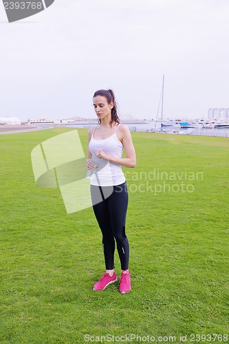 Image of Young beautiful  woman jogging  on morning