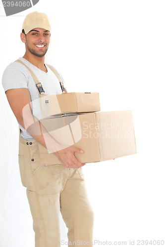 Image of Young delivery man carrying packages