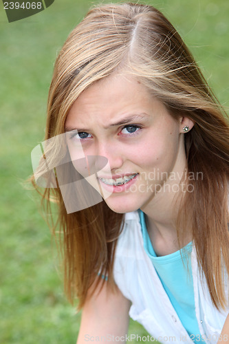 Image of Young teenage girl with puzzled expression