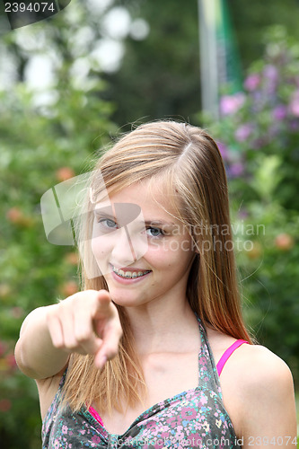 Image of Happy teenage girl pointing at the camera