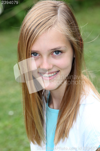 Image of Smiling teenage girl with braces on her teeth