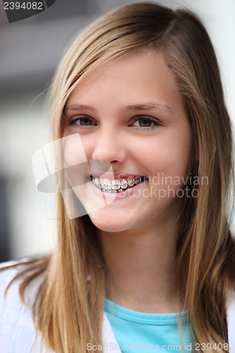 Image of Smiling teenage girl wearing dental braces