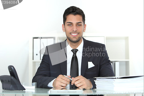 Image of Confident successful businessman at his desk