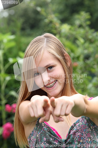 Image of Young woman pointing her fingers at the camera