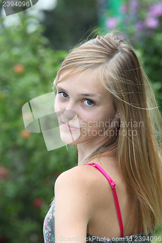Image of Pretty teenager looking back over her shoulder