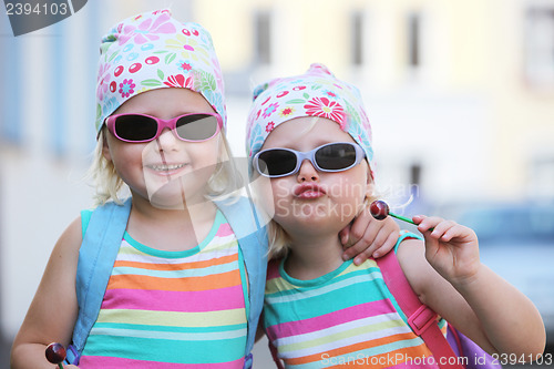 Image of Two little identical twins in sunglasses