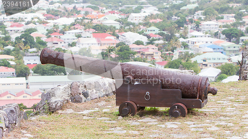 Image of Very old rusted canon on top of an old wall