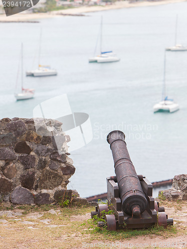 Image of Very old rusted canon pointing at a bay