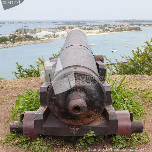 Image of Very old rusted canon pointing at a bay