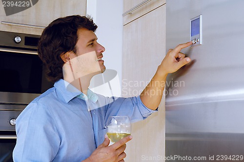 Image of man looking on refrigerator