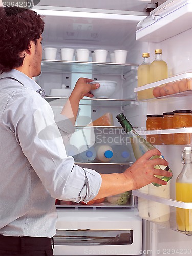 Image of Man standing near freezer l