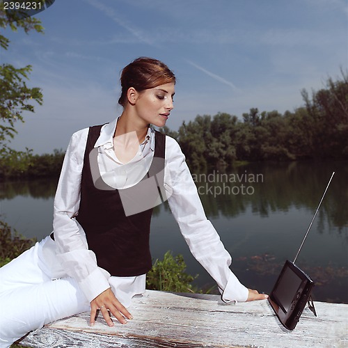 Image of a woman with laptop in park