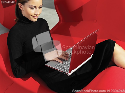 Image of woman with laptop on the sofa a
