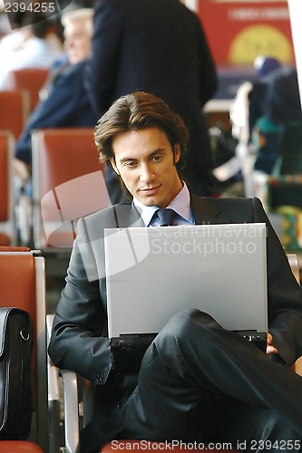 Image of businessman sitting in the airport b