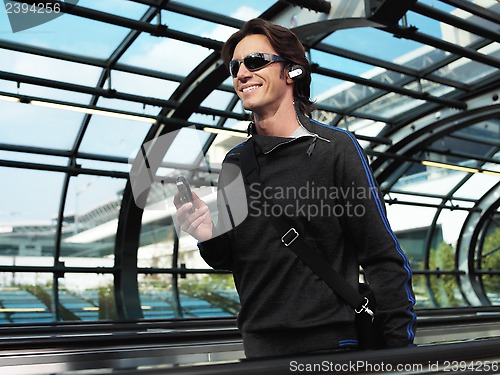 Image of businessman walking in airport jilo