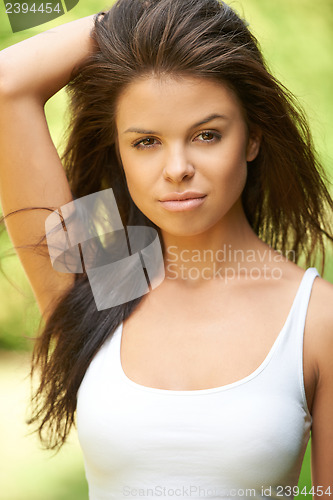 Image of Beautiful brunette woman relaxing at green surroundings