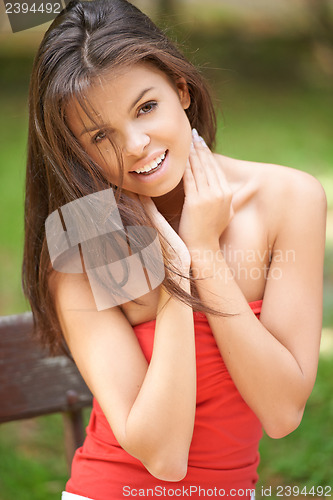 Image of Happy young woman outdoors in the garden