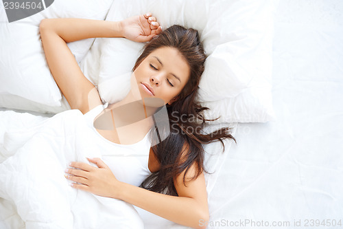 Image of Beautiful girl sleeping in white bedding