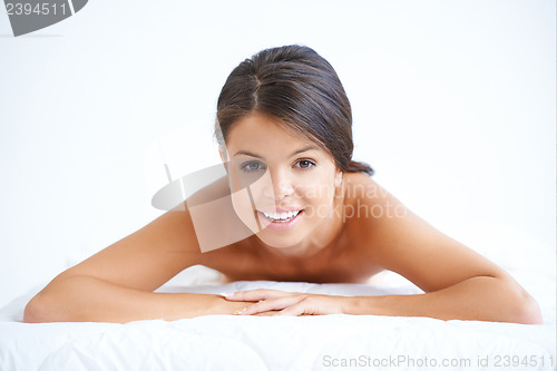 Image of Attractive woman lying on her stomach