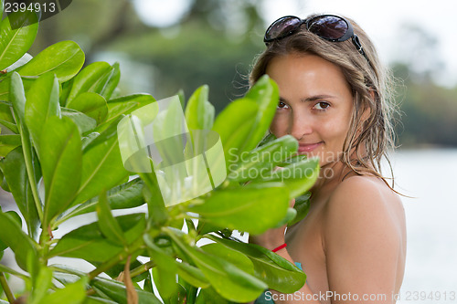 Image of Portrait of young beautiful woman getting through the jungle