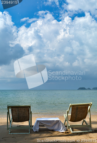 Image of sun chairs on tropical beach