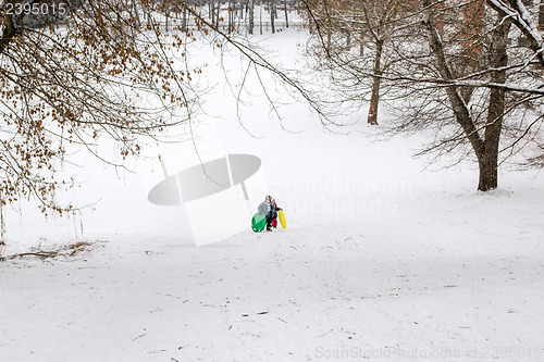 Image of children climb the mountain in winter time 