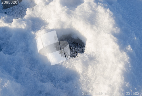 Image of Closeup frozen fishing ice hole winter lake shadow 