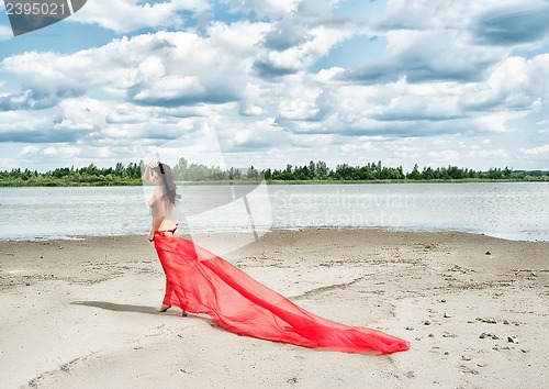 Image of Attractive naked girl on river bank