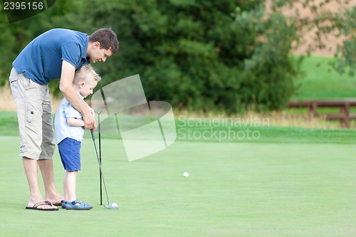 Image of family golfing