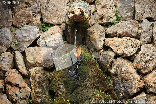 Image of Small fountain in a rock wall